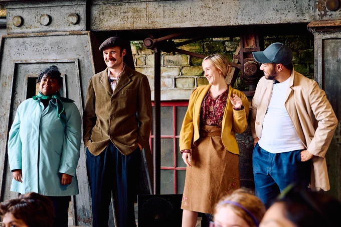 Cherie as Miriam in a blue coat. Miles as Alan in a corduroy  jacket and flat cap. Emily as Eva in a Yellow jacket and brown skirt. Reece as Kevin in a baseball cap and trench coat.