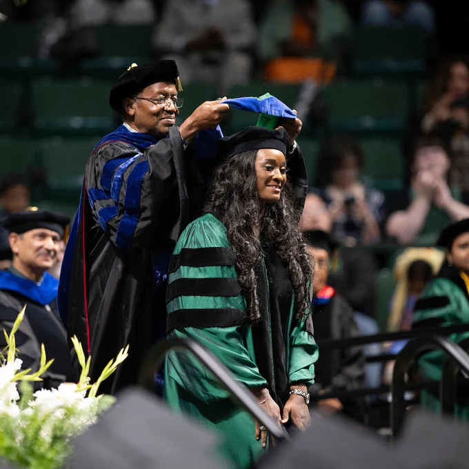 Graduate getting hooded at a UNT Spring 2024 commencement ceremony.
