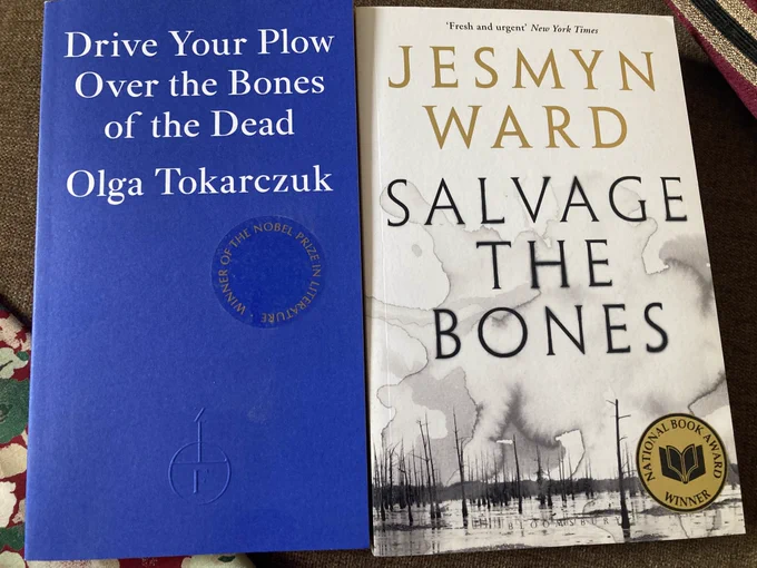 A photo of two paperback books, side by side, front covers facing the camera. On the left is “Drive Your Plow Over the Bones of the Dead” by Olga Tokarczuk. On the right is “Salvage the Bones” by Jesmyn Ward.