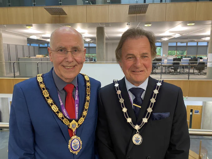Newly elected Chair Cllr Pat Hanlon with his chain of office stands next to his Vice Chair Cllr Phil Wittam who is wearing his chain.