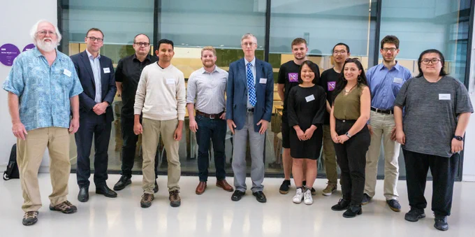 Nicholas Higham poses in a group photo with some of his former Ph.D. students.