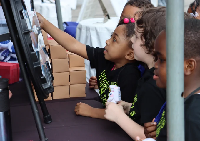 Visitors spin a wheel to claim a prize at the booth hosted by the Ohio Department of Higher Education. 