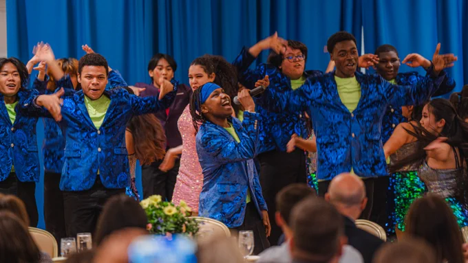 Students sing and dance