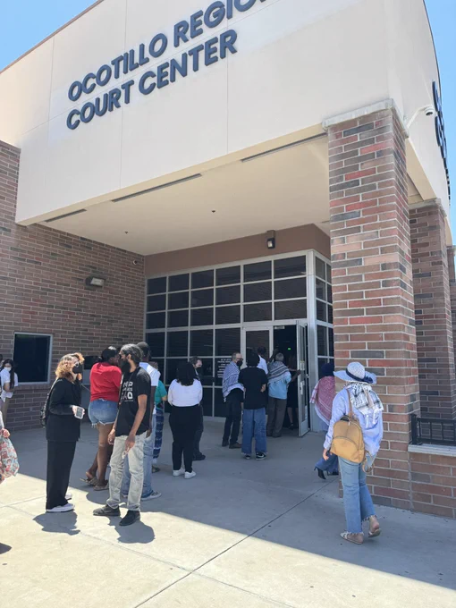 People with legal business stand in a line out the door to get inside Ocotillo Regional Court Center in Chanlder, Ariz., on May 14, 2024.