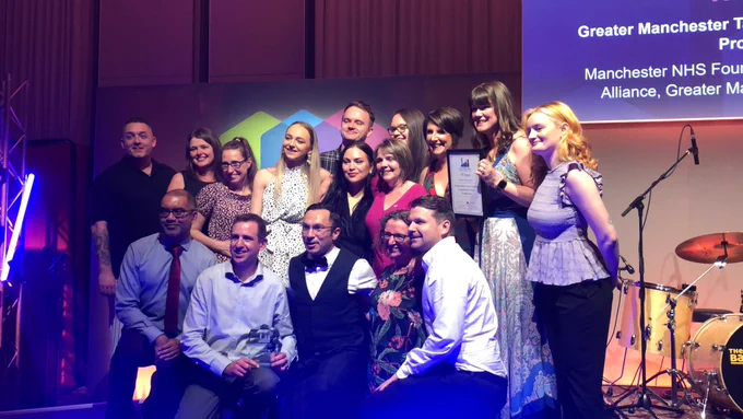 The Greater Manchester Targeted Lung Health Check programme team collecting their award on stage
