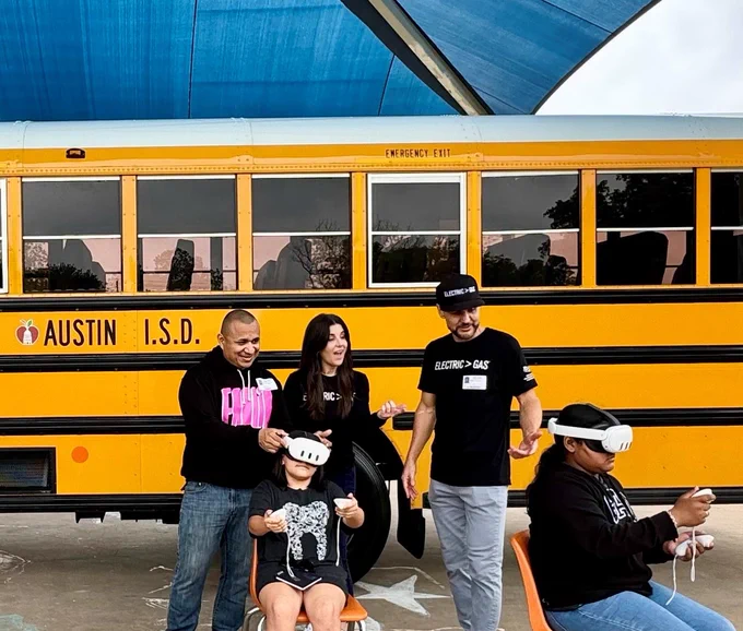 Image of students experiencing an electric vehicle virtual reality demo.