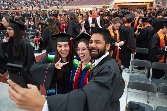 Three graduates taking a selfie together