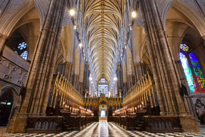 The quire stalls in Westminster Abbey, with a vaulted stone ceiling above