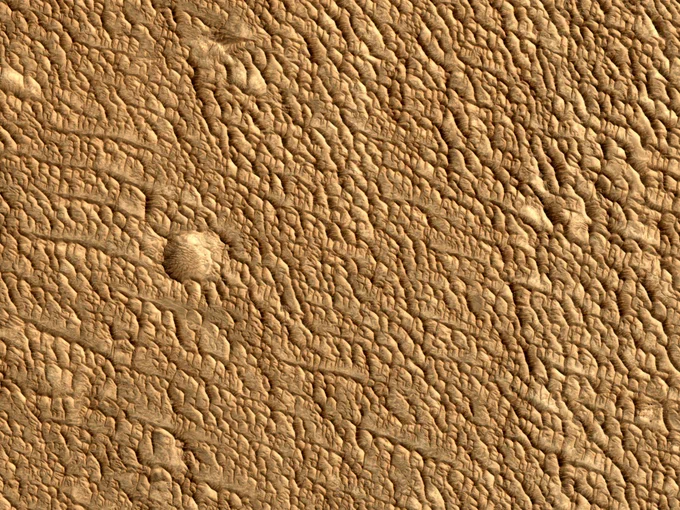 Enhanced color cutout shows a closeup of the rippled terrain. (Credit: NASA/JPL-Caltech/UArizona)