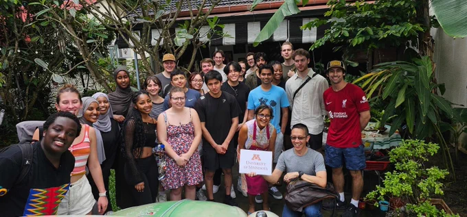 Students and professors pose outside 