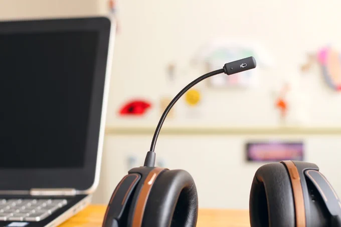 A pair of headphones with microphone. Image by Petr Macháček, available for free use via Unsplash
 
