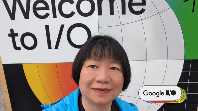Selfie of GDE Margaret Maynard-Ried smiling in front a signage that reads "Welcome to I/O" at the Google I/O event