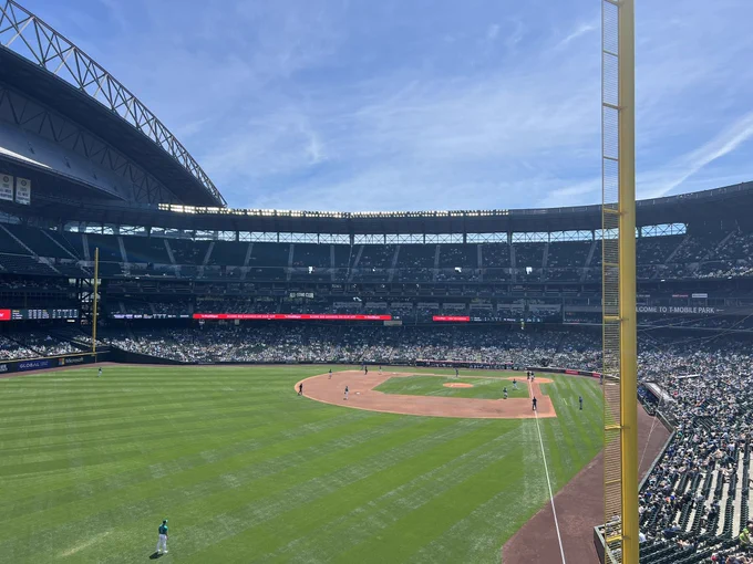 Photo from the left field bleachers inside T-Mobile Park in Seattle. It’s a bright sunny day and the sky is clear.
