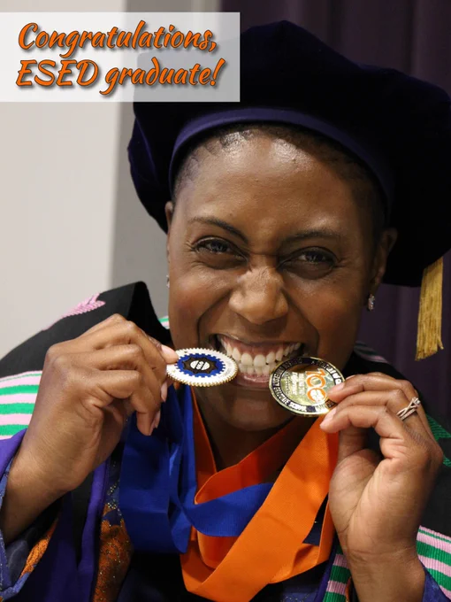 Wysheka Austin poses with her medallions. She is wearing a stole and Clemson's doctoral regalia.