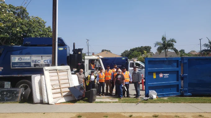 Hamilton Neighborhood Association volunteers pose with recycling and trash they cleaned up.