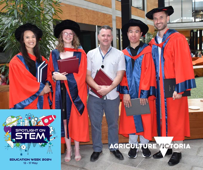 Graduates in gowns with their supervisor. Education Week Spotlight on Stem logo in left corner of image.