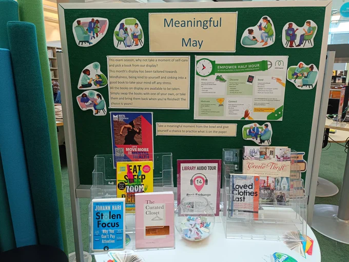 A display showing books and resources around mental health and mindfulness.