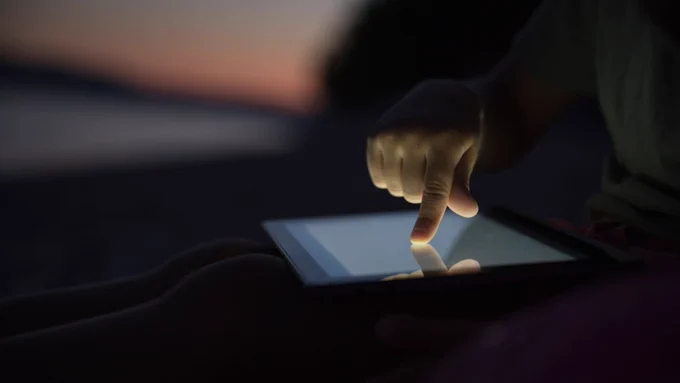 This is an image of a child using a tablet.