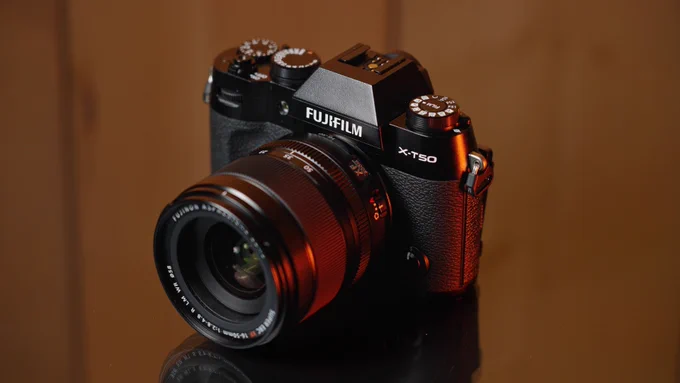 Photograph of Fujifilm X-T50 on a glass table.
