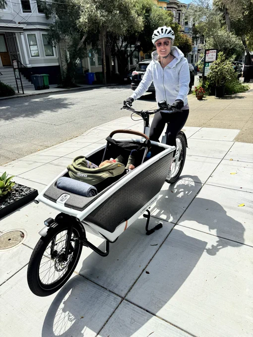 Me on a cargo e-bike with a baby in a car seat in the basket