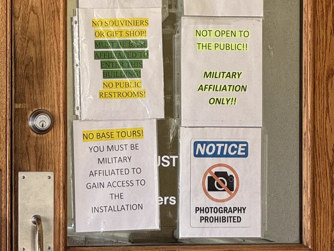 Signs on the door of the visitor center indicating it’s not open to the public