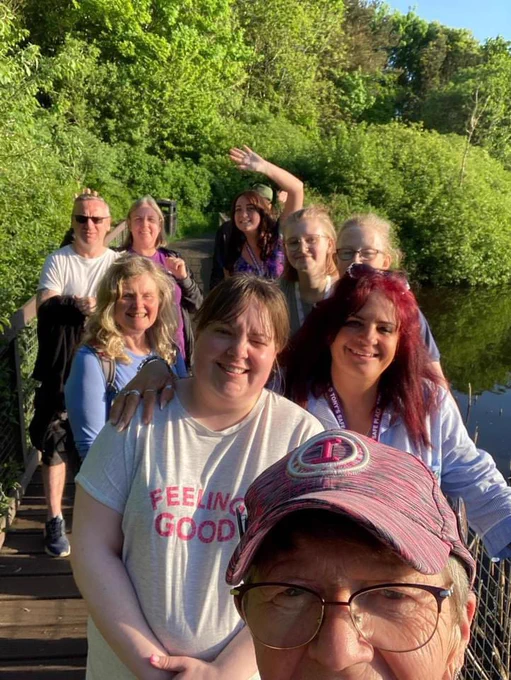 Group of people smiling taking a selfie