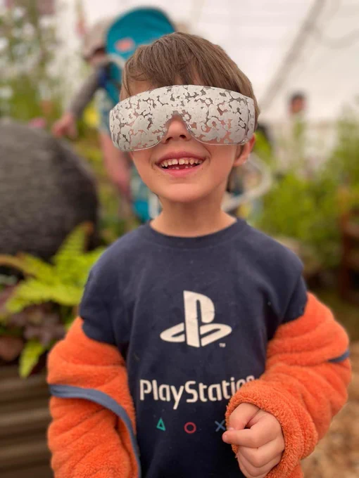 A young child trying on Simulation Specs to simulate Diabetic Retinopathy!