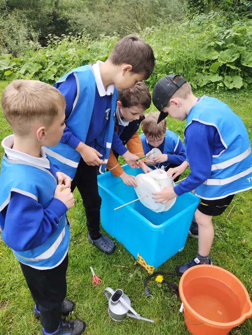 Children making a waterwheel