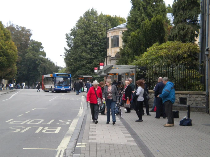 People walking and standing near a bus stop.  Image: Keith Edkins