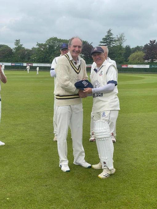 Richard Merriman presenting Paul Garlick with his cap