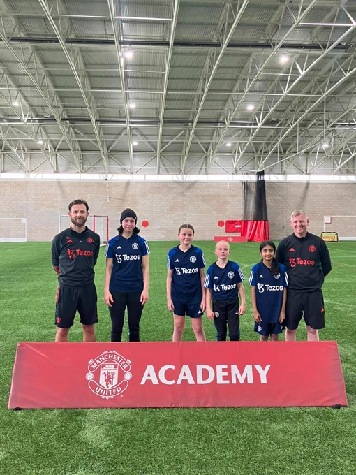 Girls Academy players with club staff.