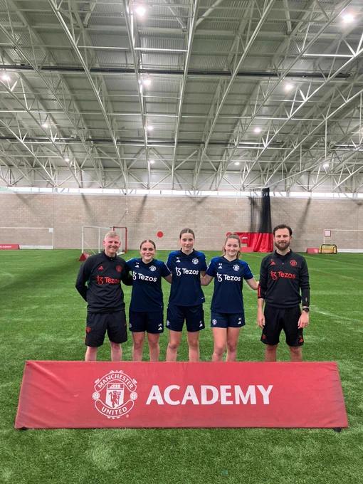 Girls Academy players with club staff.