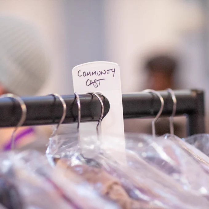 Garment with a sign reading "Community Cast"