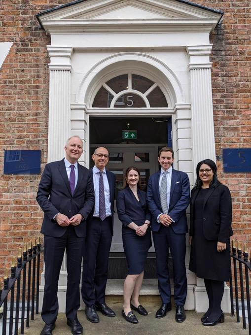 Sam Townend KC, Amrit Kaur Dhanoa and barristers from King's Chambers standing in the doorway of King's Chambers 