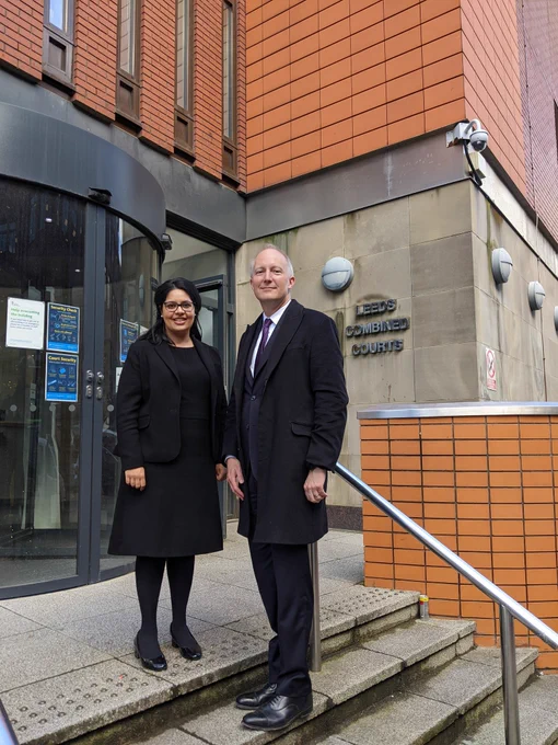 Sam Townend KC and Amrit Kaur Dhanoa standing on the steps of Leeds Combined Courts.