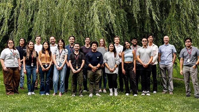 Dr. Emilio Alarcón and team outside in front of trees.