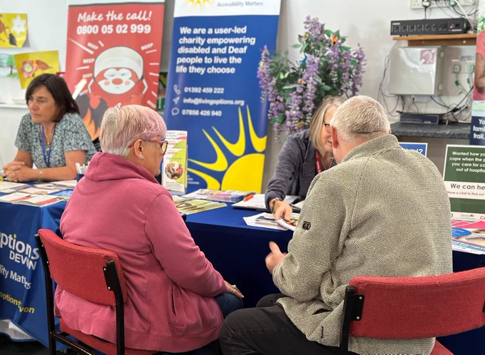 Hayley from Devon Carers talking to clients about their services.