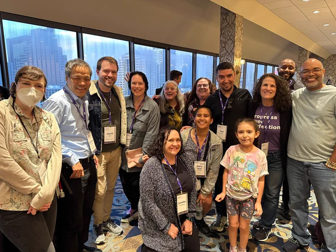 Group photo in front of a window inside a hotel reception space