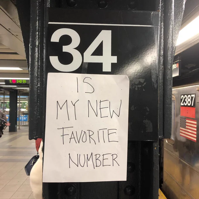 34th Street subway station with attached sign that says IS MY NEW FAVORITE NUMBER