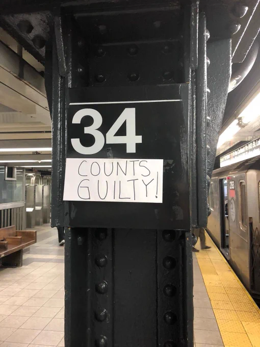 34th Street subway station with attached sign that says COUNTS GUILTY!