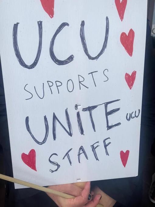 Picket line placard held by a UCU member which reads "UCU supports Unite UCU staff"