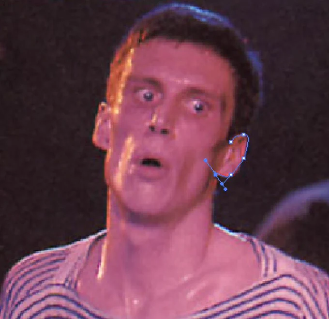 Bez from the band Happy Mondays, he has a badly drawn vector line on his ear.