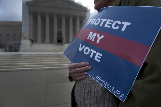 Alabama residents in front of the U.S. Supreme Court on Feb. 27, 2013 when the Court heard oral arguments in Shelby County v. Holder, a case that ultimately dismantled key protections of the Voting Rights Act. (Photo by Chip Somodevilla/Getty Images)