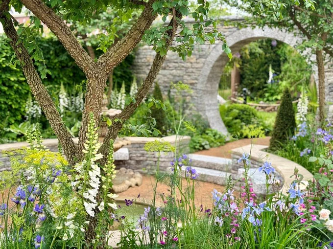 A walled garden with a stone archway 