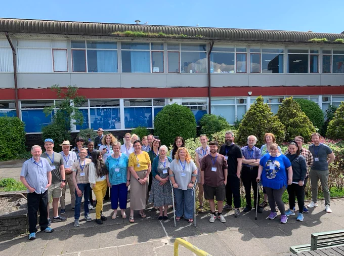 A group shot of our jury members gathered together in the courtyard at Moorclose Community Centre in Workington.  