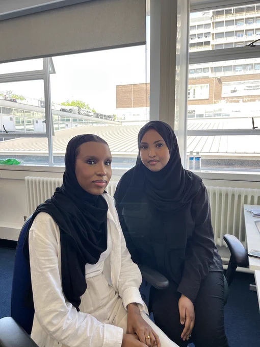 Team photograph of two HR colleagues at Imperial College Healthcare. They are sitting down and smiling towards the camera.
