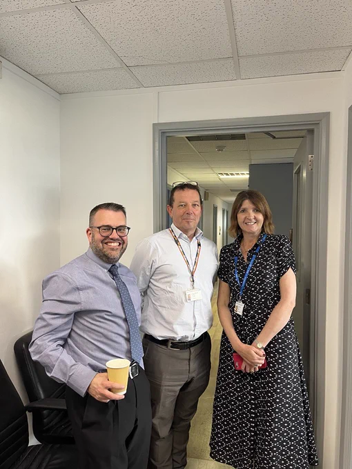 Team photograph of HR colleagues at Imperial College Healthcare. Staff are standing in a row and smiling towards the camera.
