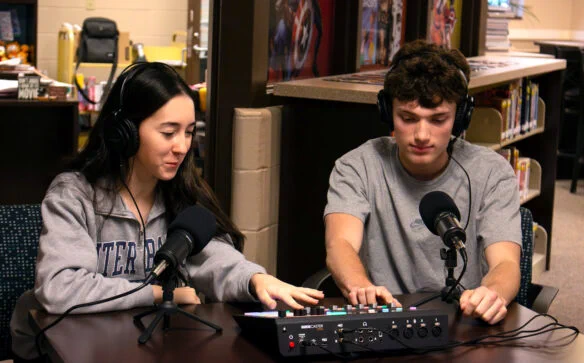 Addison Spurrier and Jacob Coffey, students at Daviess County High School, work in the podcast studio