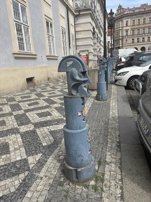 Blue metal cubist traffic bollard.