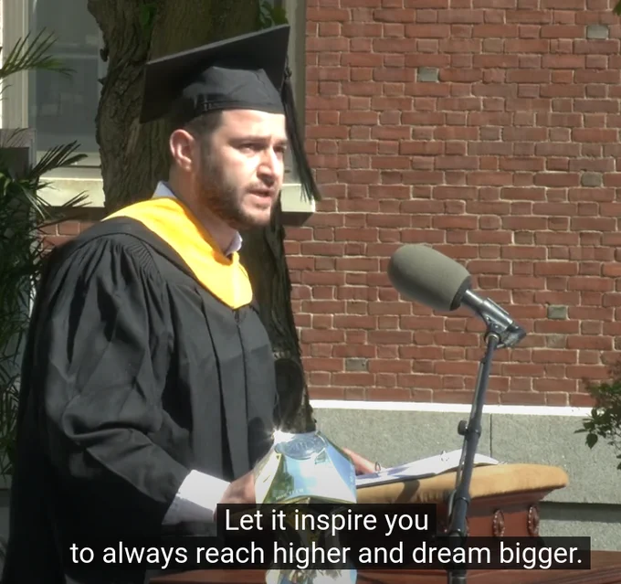 Picture of  Ijaz Ul Haq addressing UVM graduates as president of the Graduate Student Senate, with subtitle of speech excerpt: "Let it inspire you to always reach higher and dream bigger." 